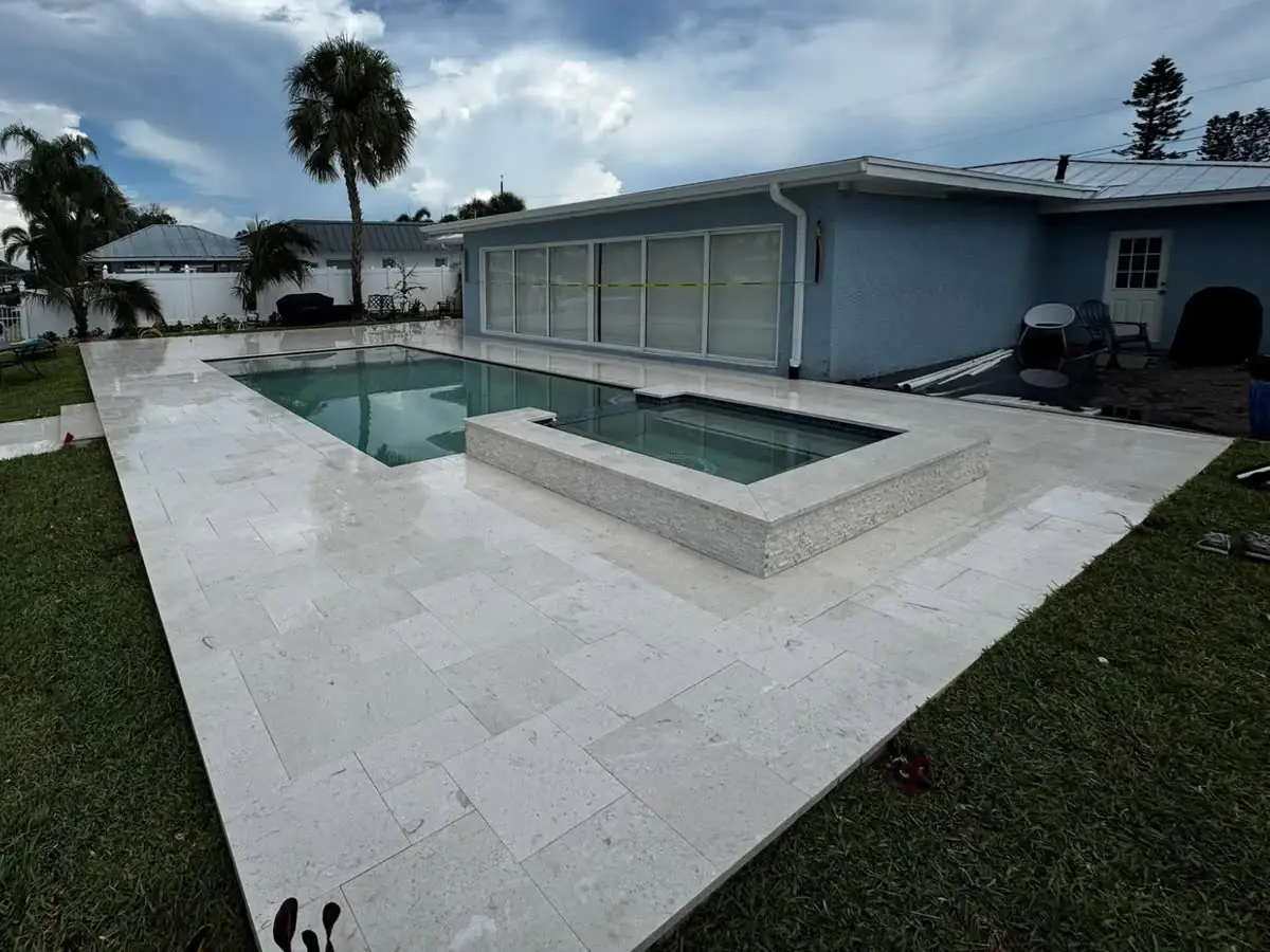 After: the travertine pool deck and spa cleaned and sealed, the stone bright again.