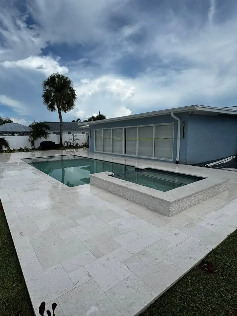 After: the travertine pool deck and spa cleaned and sealed, the stone bright again.
