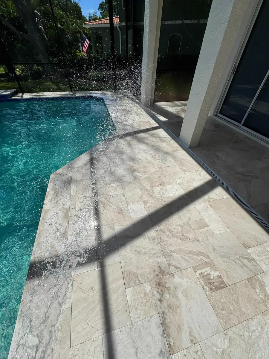A long travertine walk beside a narrow pool.